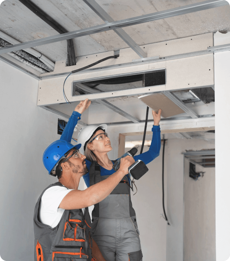 man and women repairing an AC