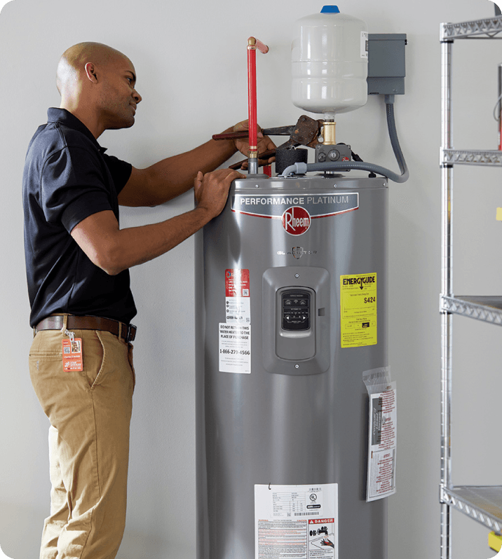 man checking water heater tank